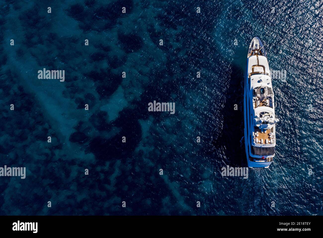 A superyacht sailing in the Mediterranean sea, from above. Stock Photo