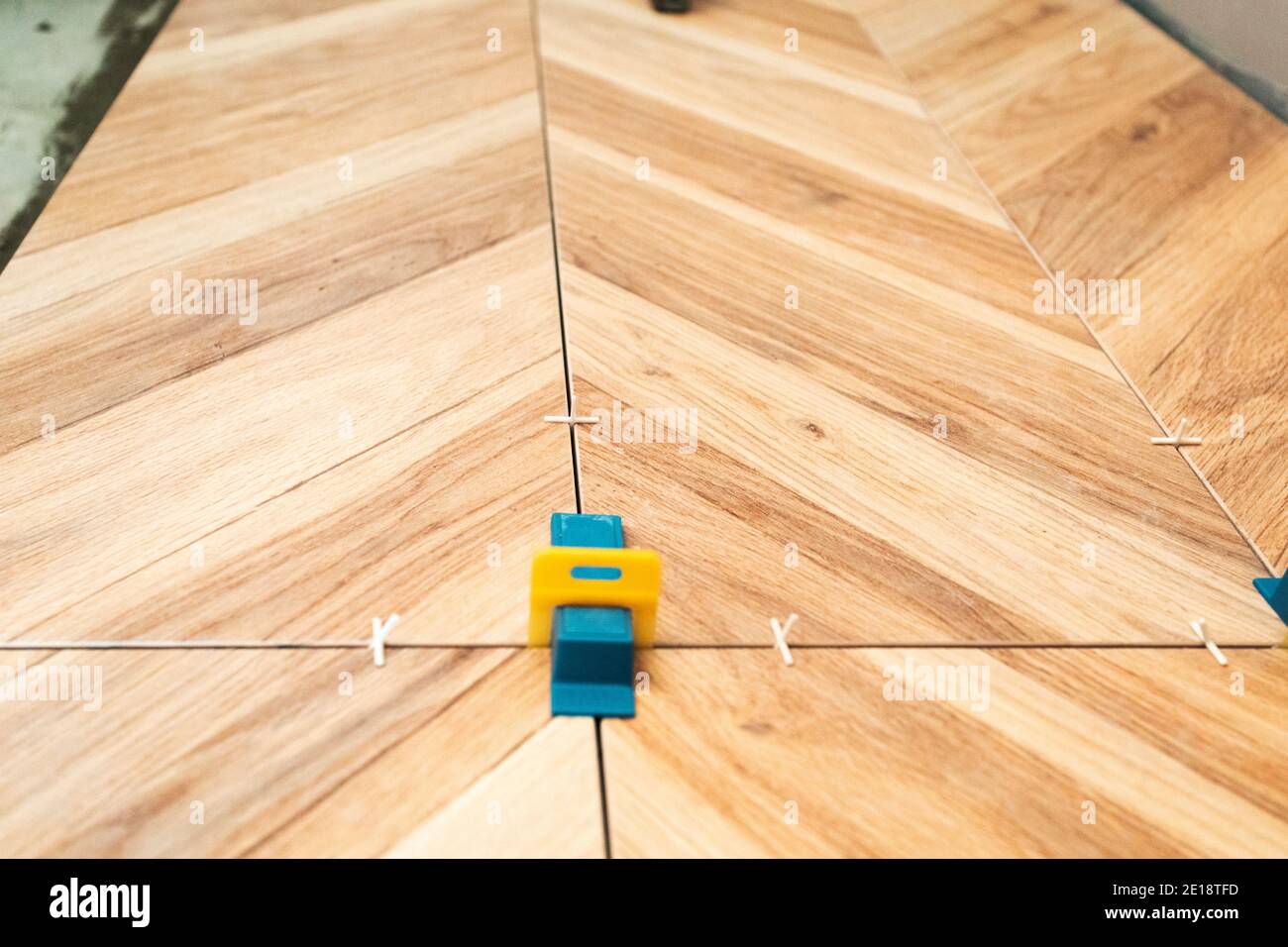 Tiling work. Layed tiles with crosses for tiles and 3d crosses Stock