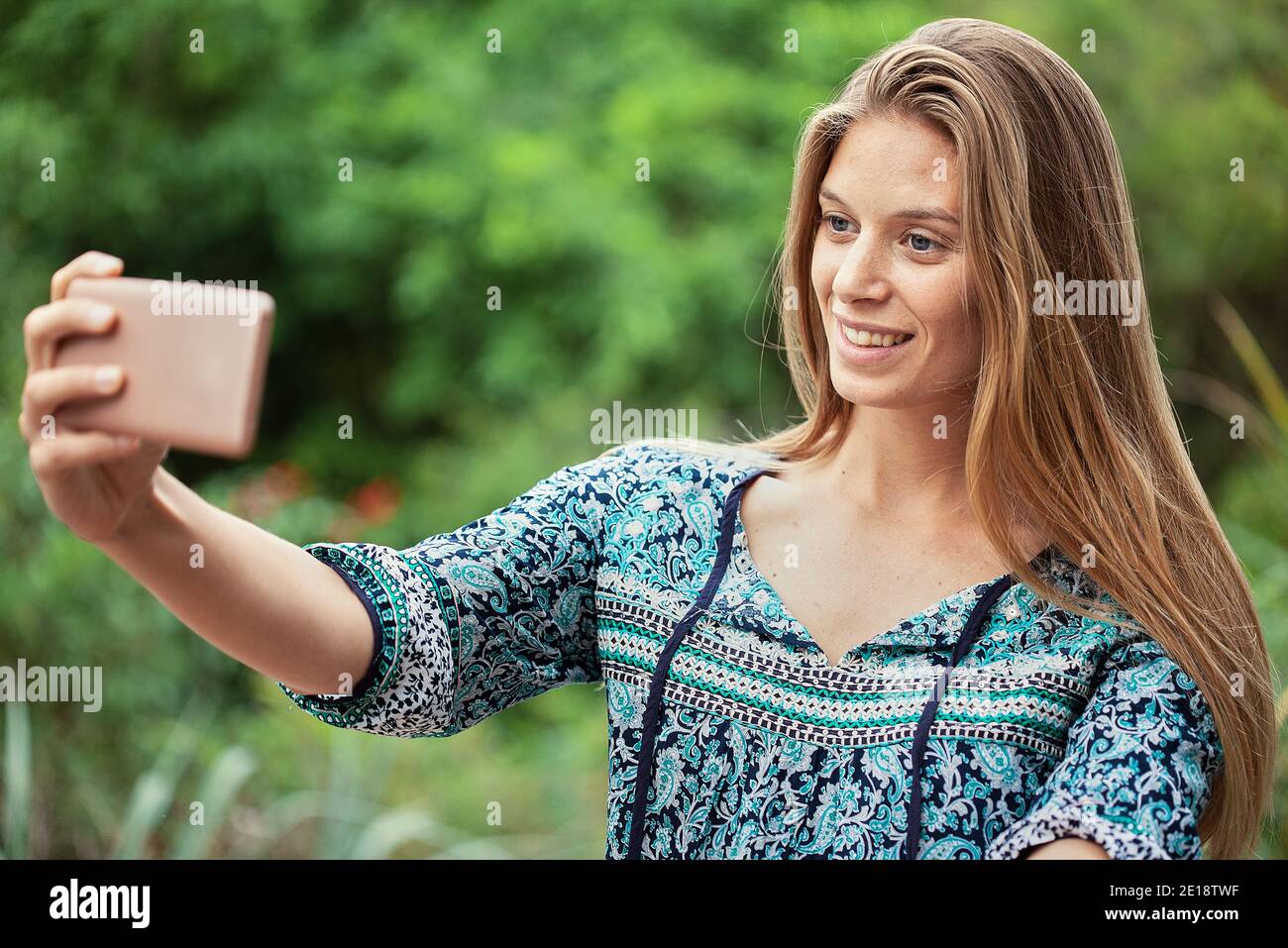 Smiling mid adult woman taking selfie Stock Photo