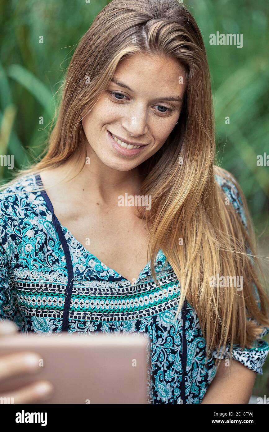 Smiling mid adult woman taking selfie Stock Photo
