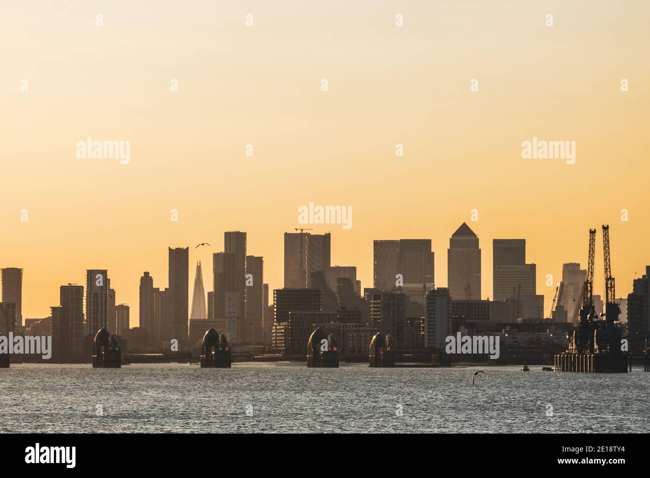 The Thames Barrier with Canary Wharf on the background. Stock Photo
