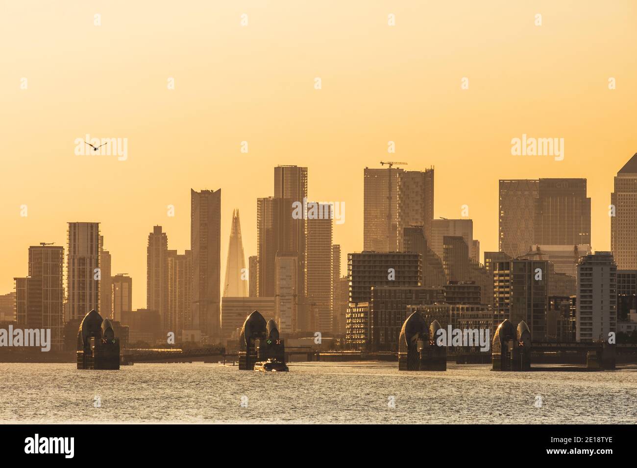 The Thames Barrier with Canary Wharf on the background. Stock Photo