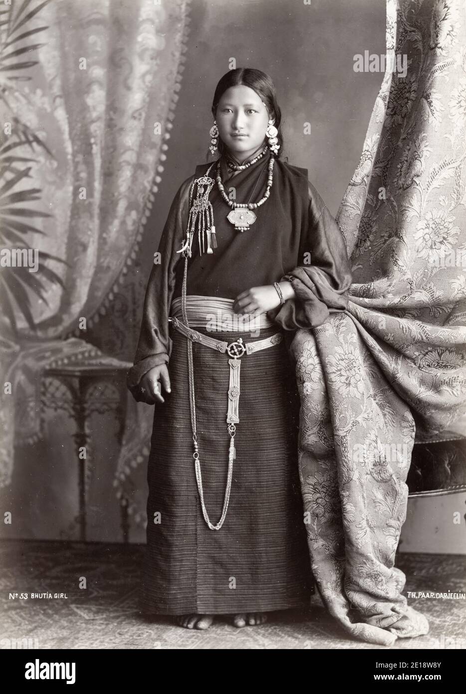 Vintage 19th century photograph - Bhutia girl. The Bhutia constitute a majority of the population of Bhutan, where they live mainly in the western and central regions of the country, and form minorities in Nepal and India, particularly in the Indian state of Sikkim. Stock Photo