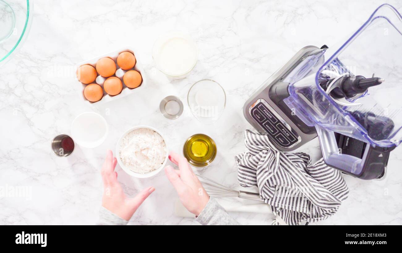 Flat lay. Mixing ingredient in an electric blender to make the crepes