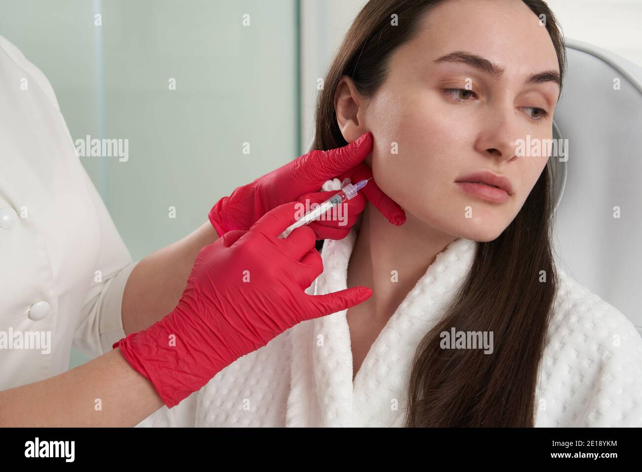 Cosmetologist makes lipolytic injections to burn fat on the chin