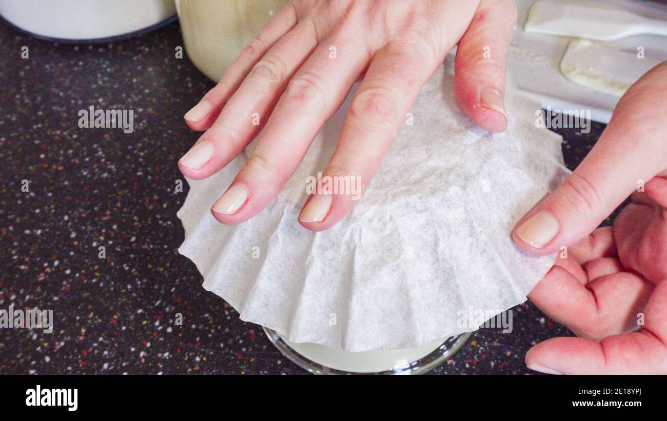 Feeding sourdough starter with water and flour Stock Photo Alamy