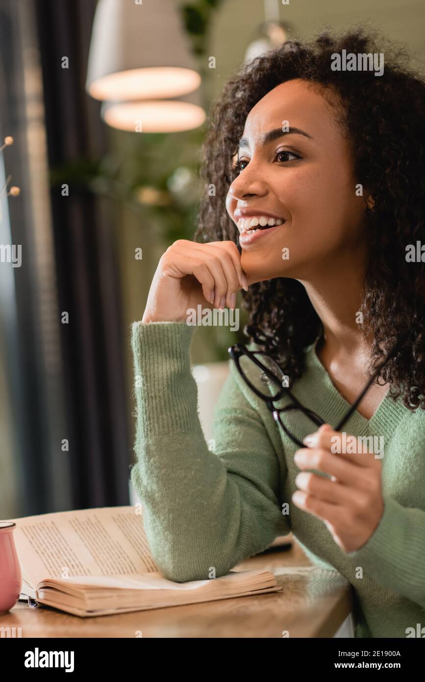 African woman smiling in cafe hi-res stock photography and images - Alamy