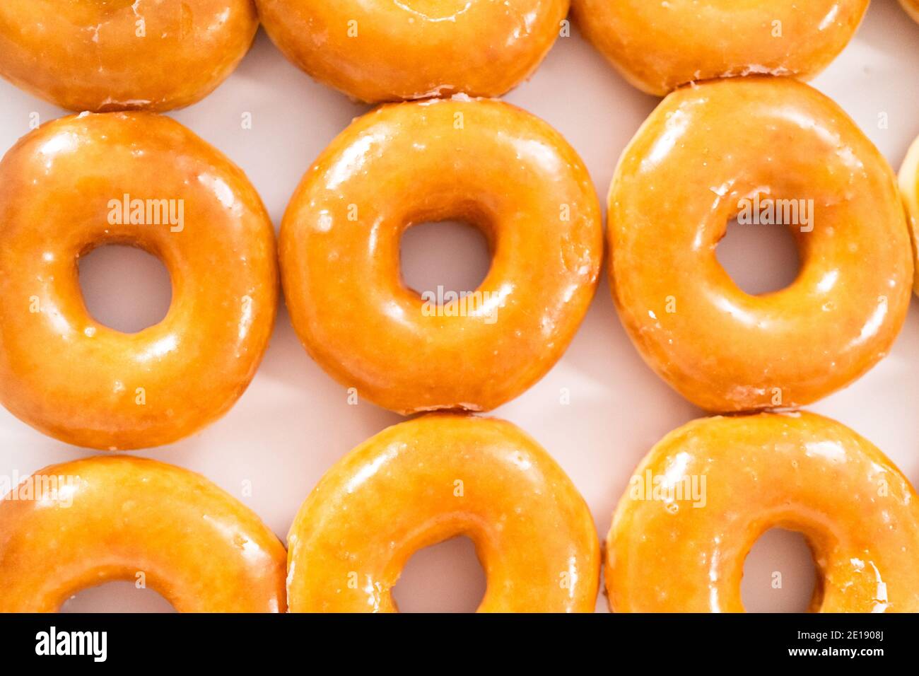 Plain glazed storebought doughnuts in a white paper box Stock Photo