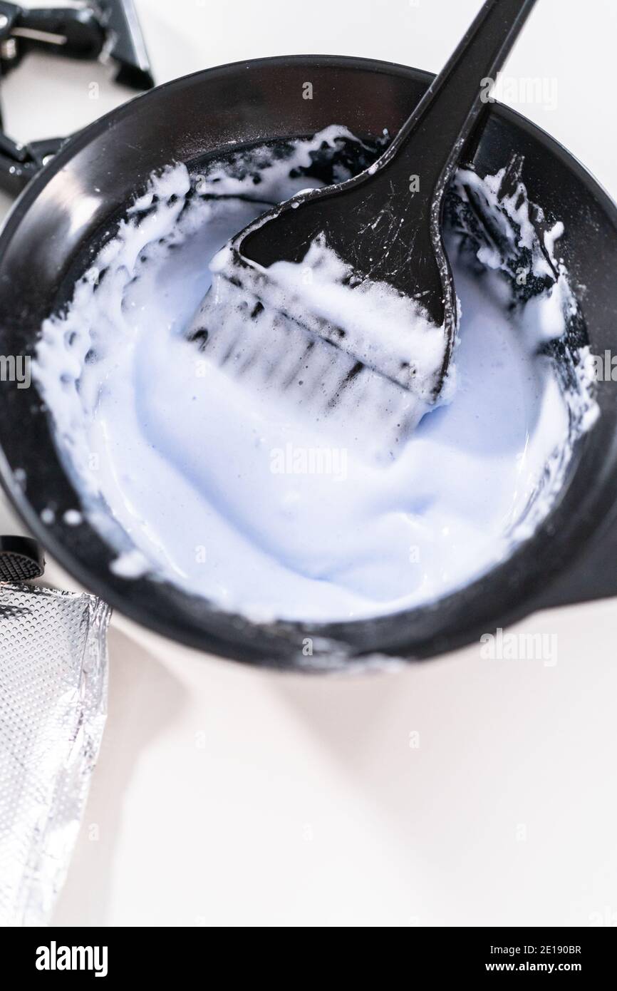 Mixing hair color dye in a black mixing bowl with a brush Stock Photo -  Alamy