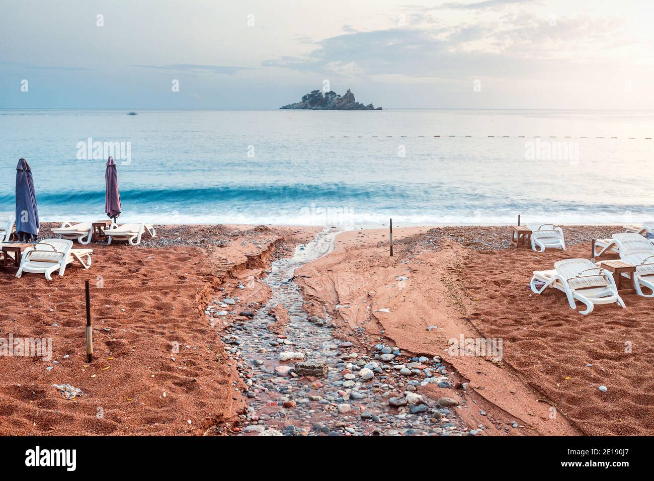 The beach after the tsunami washed out sand and empty sunbeds a sad