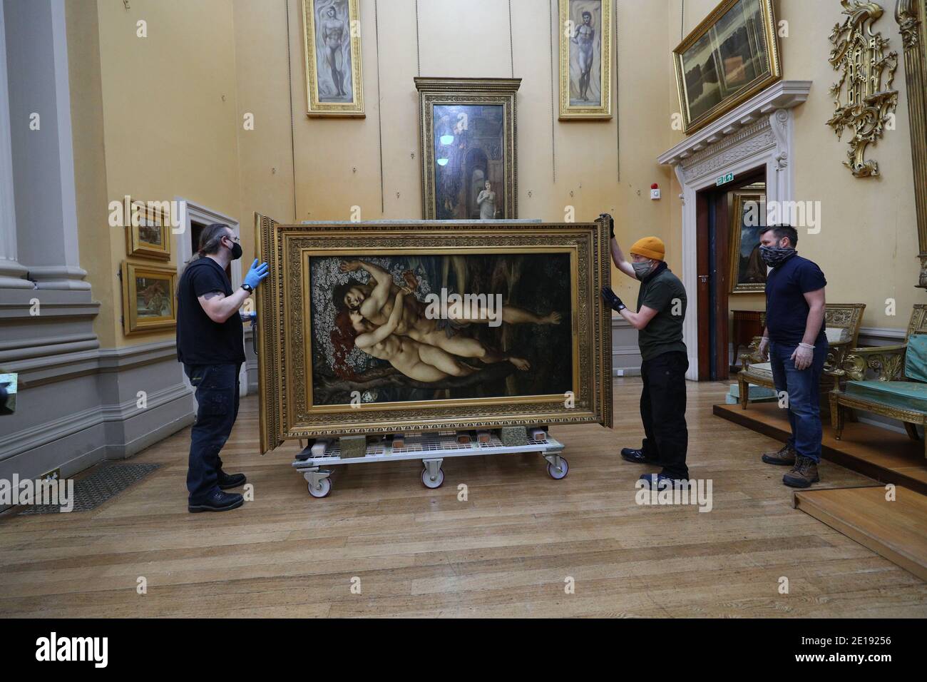 The Beguiling of Merlin by Edward Burne-Jones is prepared for hanging at the Lady Lever Art Gallery in Port Sunlight, on the Wirral, Merseyside. Three paintings - The Tree of Forgiveness and The Beguiling of Merlin, both by Edward Burne-Jones, and A Dream of the Past: Sir Isumbras at the Ford, by John Everett Millais - are returning to be re-hung at the Lady Lever Art Gallery after being loaned out to other galleries. Stock Photo