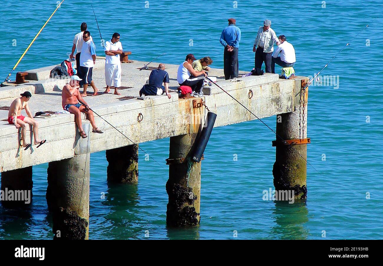ANGLING =Rod fishermen on a pier in Portugal in 2007 Stock Photo