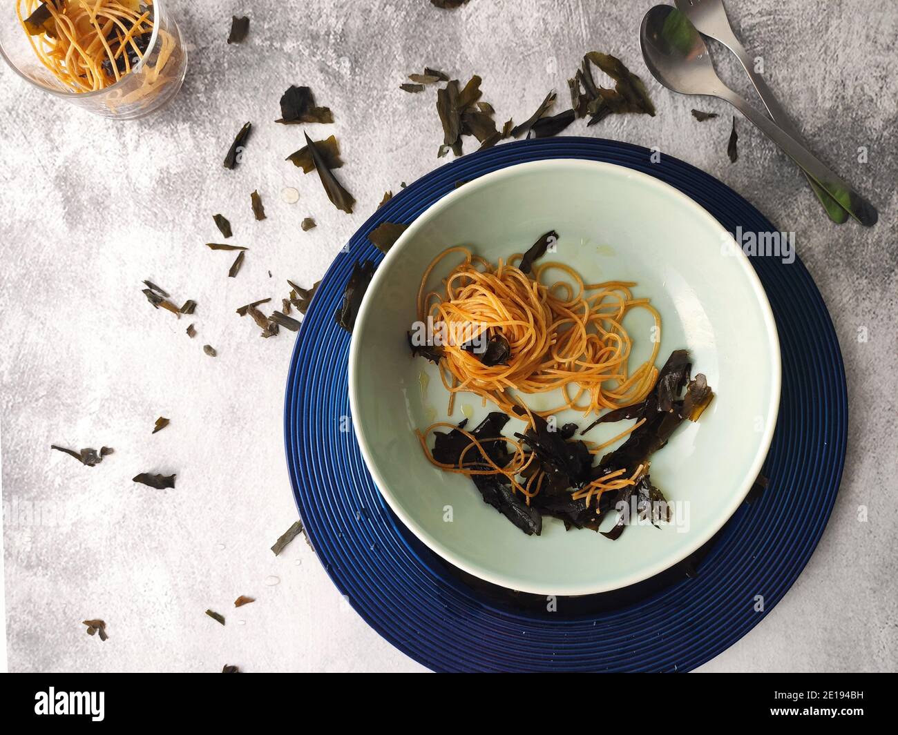 Kombu seaweed spaghetti in a blue plate Stock Photo