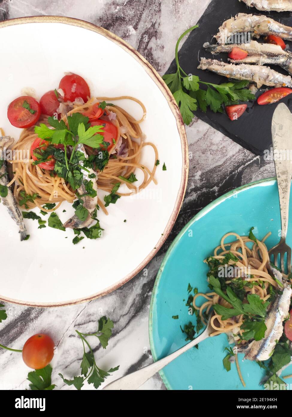 Italian pasta bowls with sardines, cherry tomatoes and fresh persil