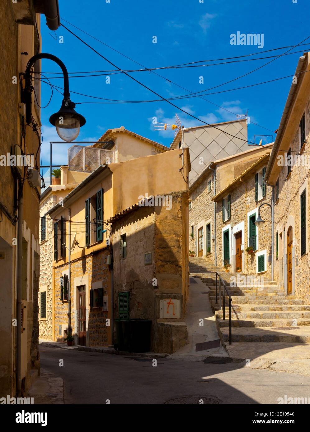 Typical Spanish houses on an empty street in Port de Soller a village on the north coast of Mallorca in the Mediterranean Balearic Islands of Spain Stock Photo