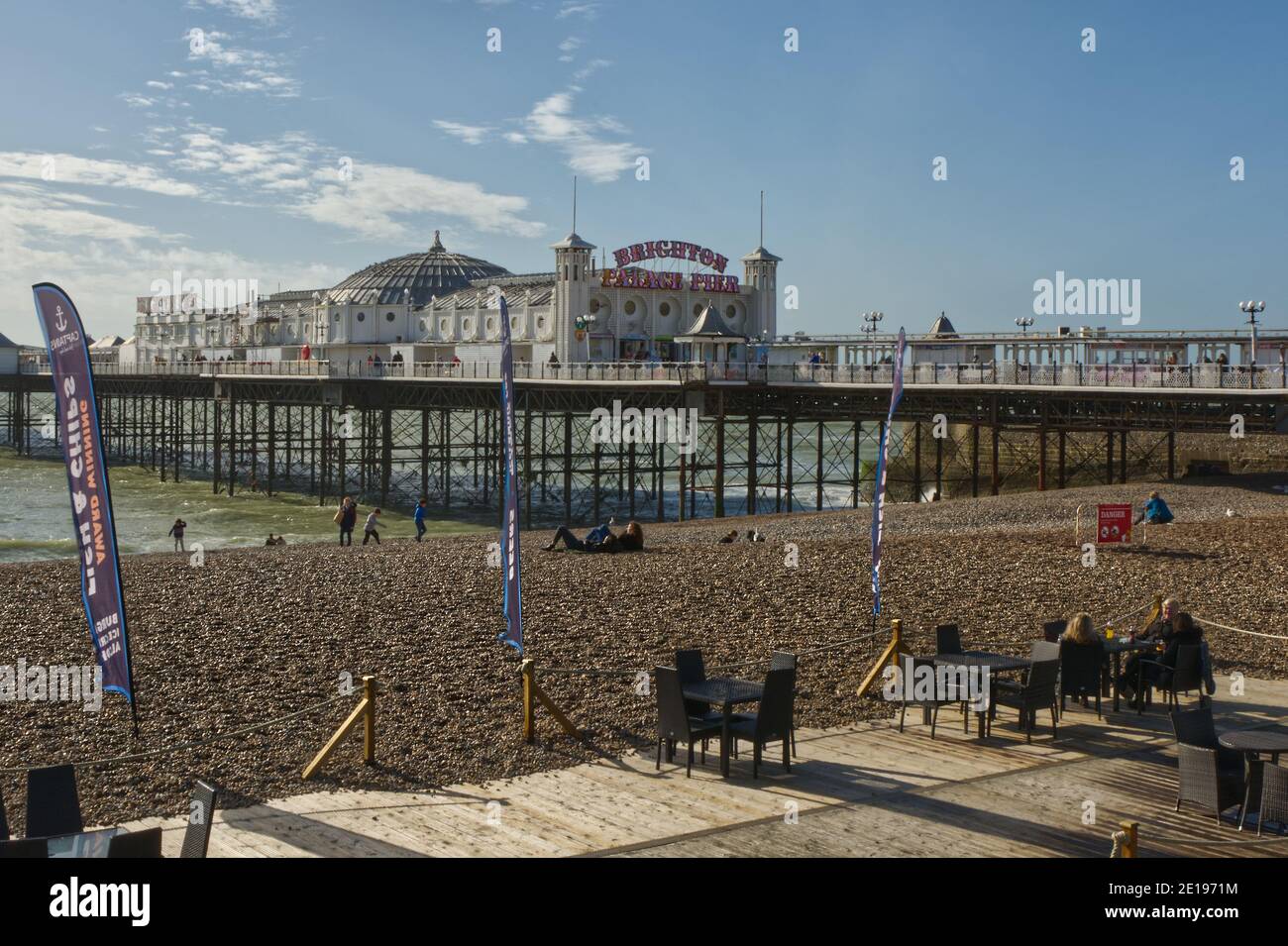 Beach and pier at Brighton, East Sussex, England. With cafe terrace. Stock Photo