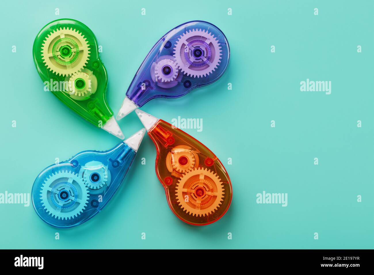 Stationery correction tapes are Multicolored on a blue background. Free space. The view from the