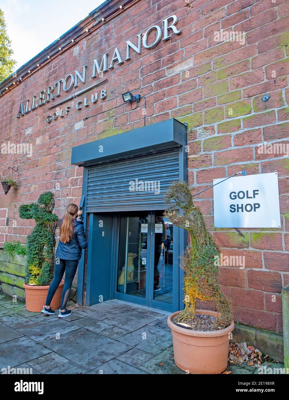 A member of staff closes up the pro shop at Allerton Manor golf club,  Liverpool, the morning after Prime Minister Boris Johnson set out further  measures as part of a lockdown in