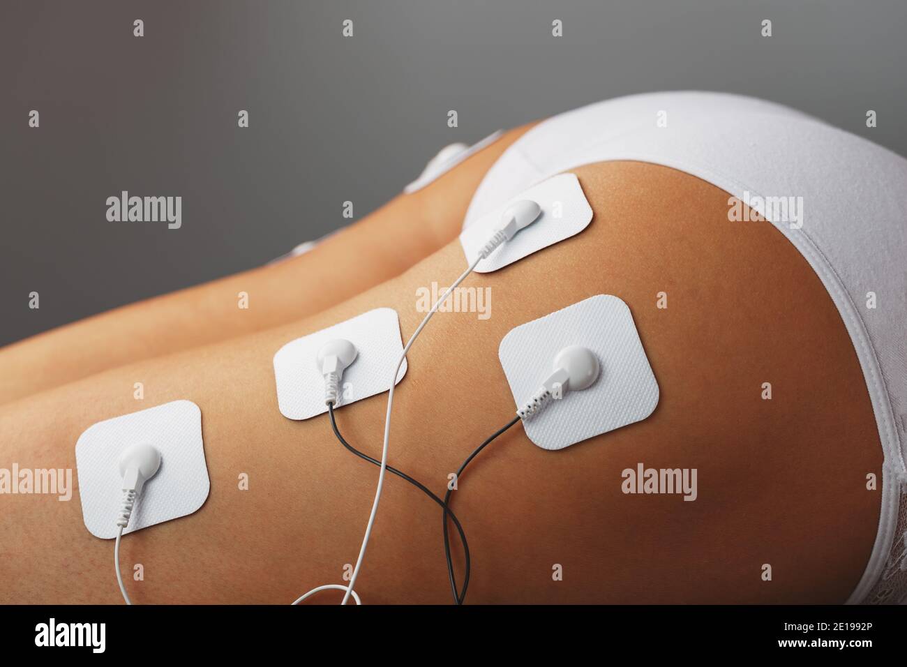 Muscle stimulator with electrodes, the massager on the buttocks and legs.  Rehabilitation and treatment, weight loss and. Soft contrast Stock Photo -  Alamy