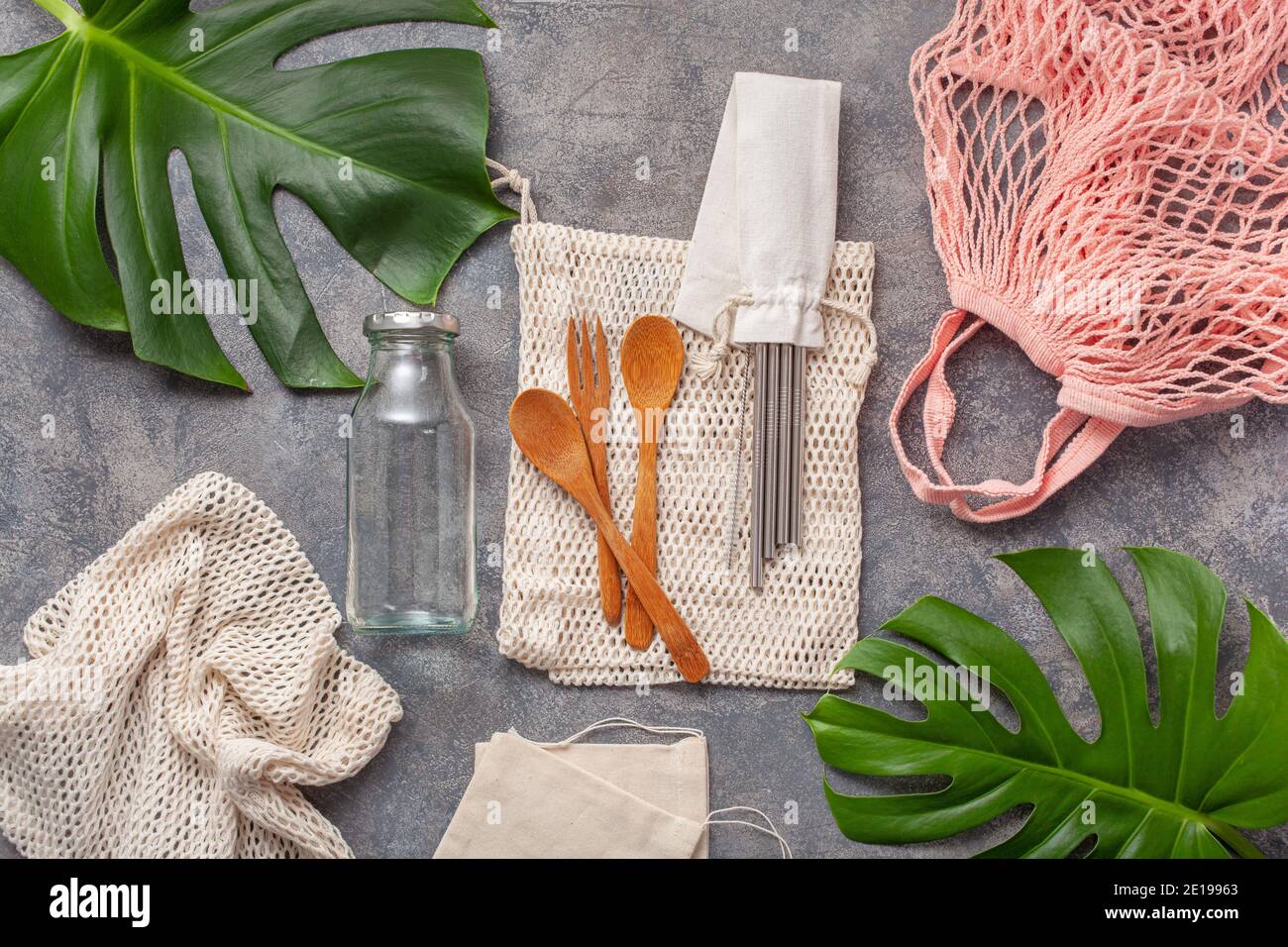 zero waste eco friendly concept. reusable cotton bag, stainless steel drinking staw, glass jar, wooden cutlery Stock Photo