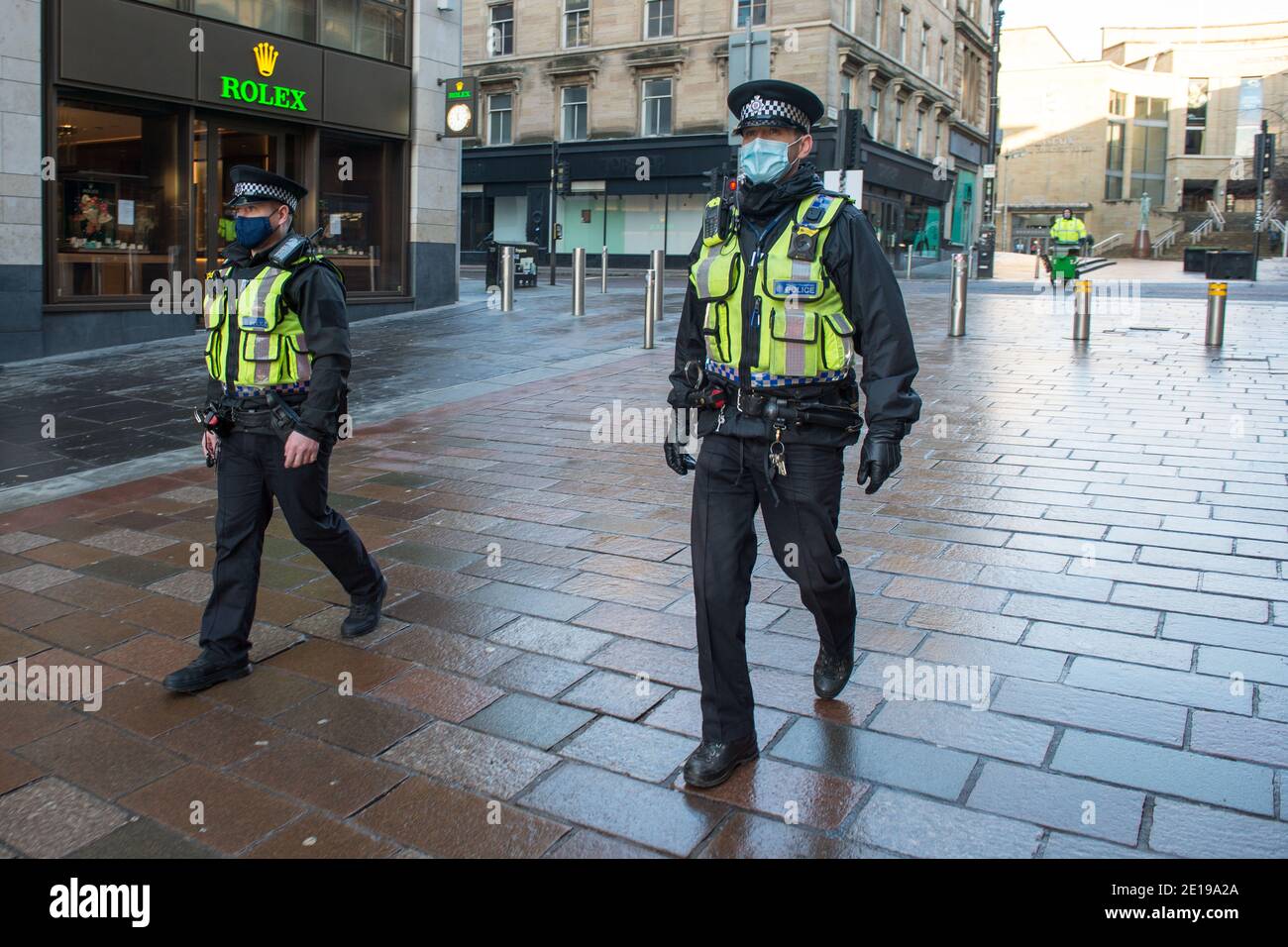 Glasgow, Scotland, UK. 5th Jan, 2021. Pictured: Police Scotland officers wearing high viz are making a highly visible presence to enforce the lockdown. Glasgow City centre looks empty and deserted during the first day Scotland is put into another lockdown. As of 00:01 this morning Scotland has been placed into another lockdown as per the Scottish First Minister's address at 2pm yesterday. Only essential travel is allowed such as going to work and essential food shopping and exercise, other than that everyone must stay in their homes. Credit: Colin Fisher/Alamy Live News Stock Photo