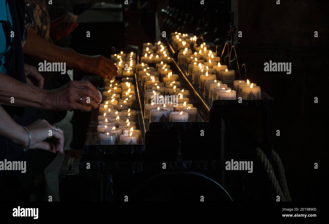 People lighting up candles in memory of deceased dead memorial