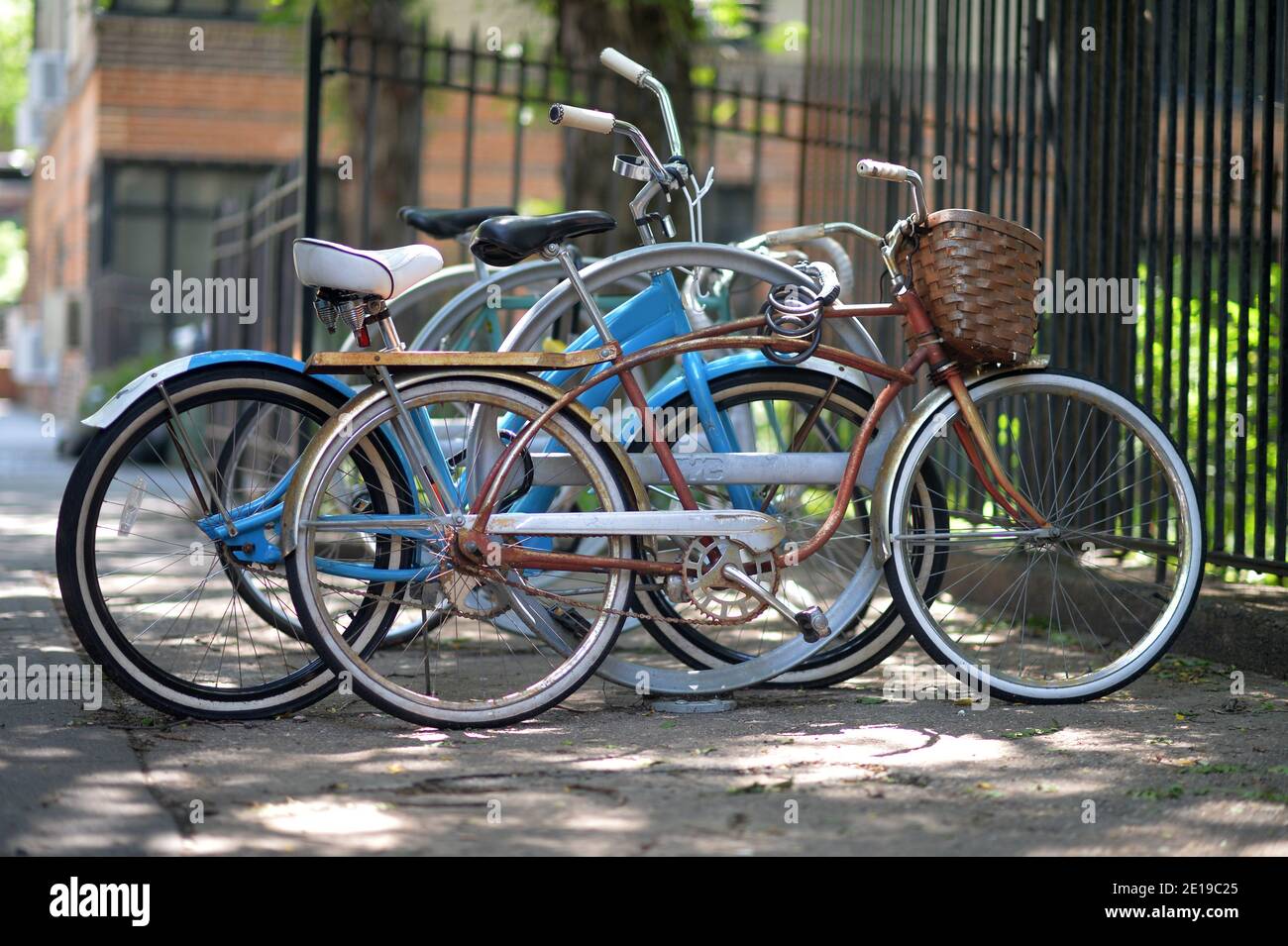 Colored bicycles are parked against the background of a city street Stock Photo