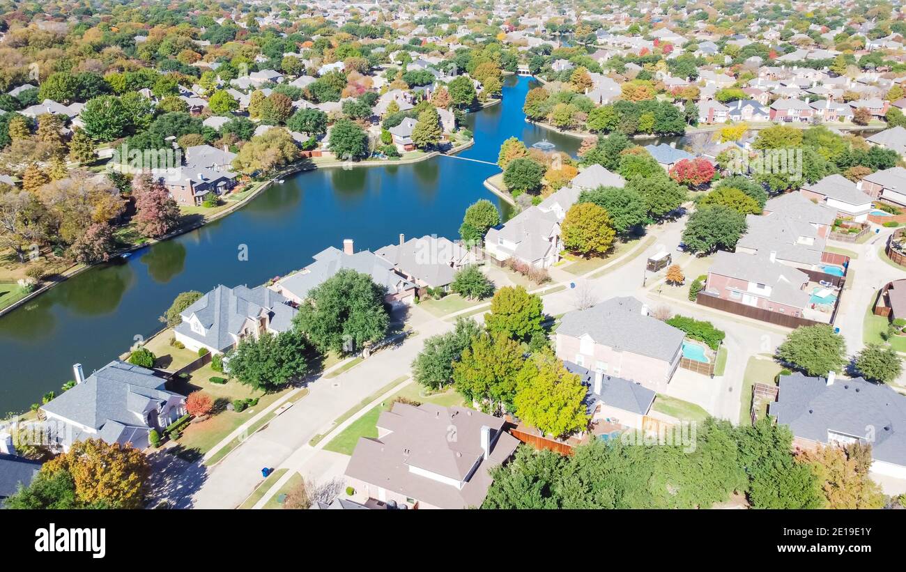 Top view upscale waterfront houses surrounded by colorful fall foliage