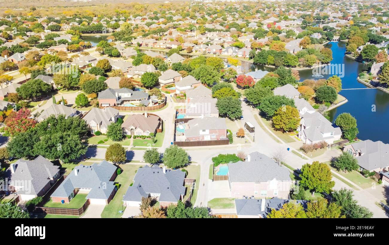 Top view upscale waterfront houses surrounded by colorful fall foliage