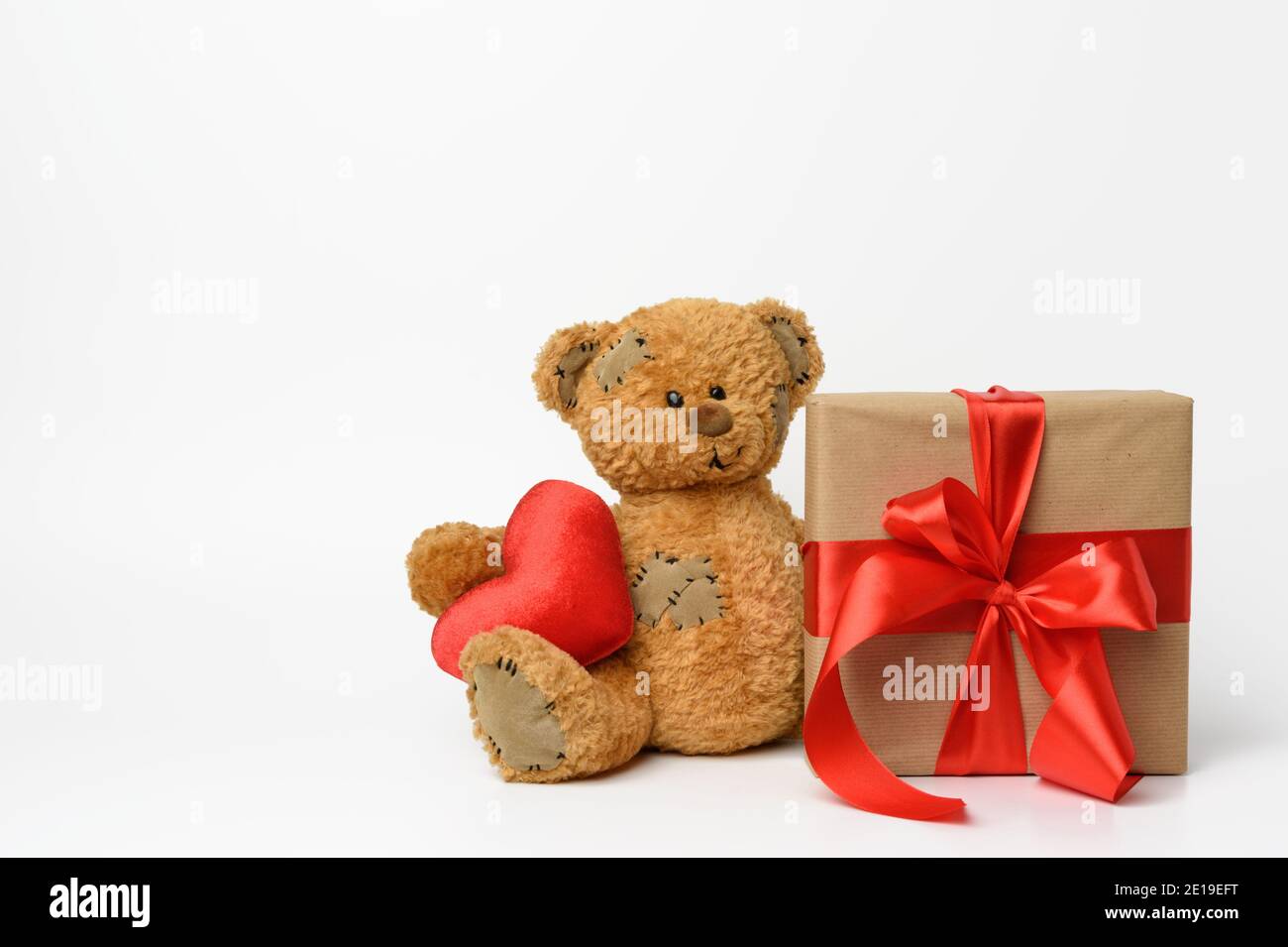 cute teddy bear holding a red heart, next to a box with a gift tied ...