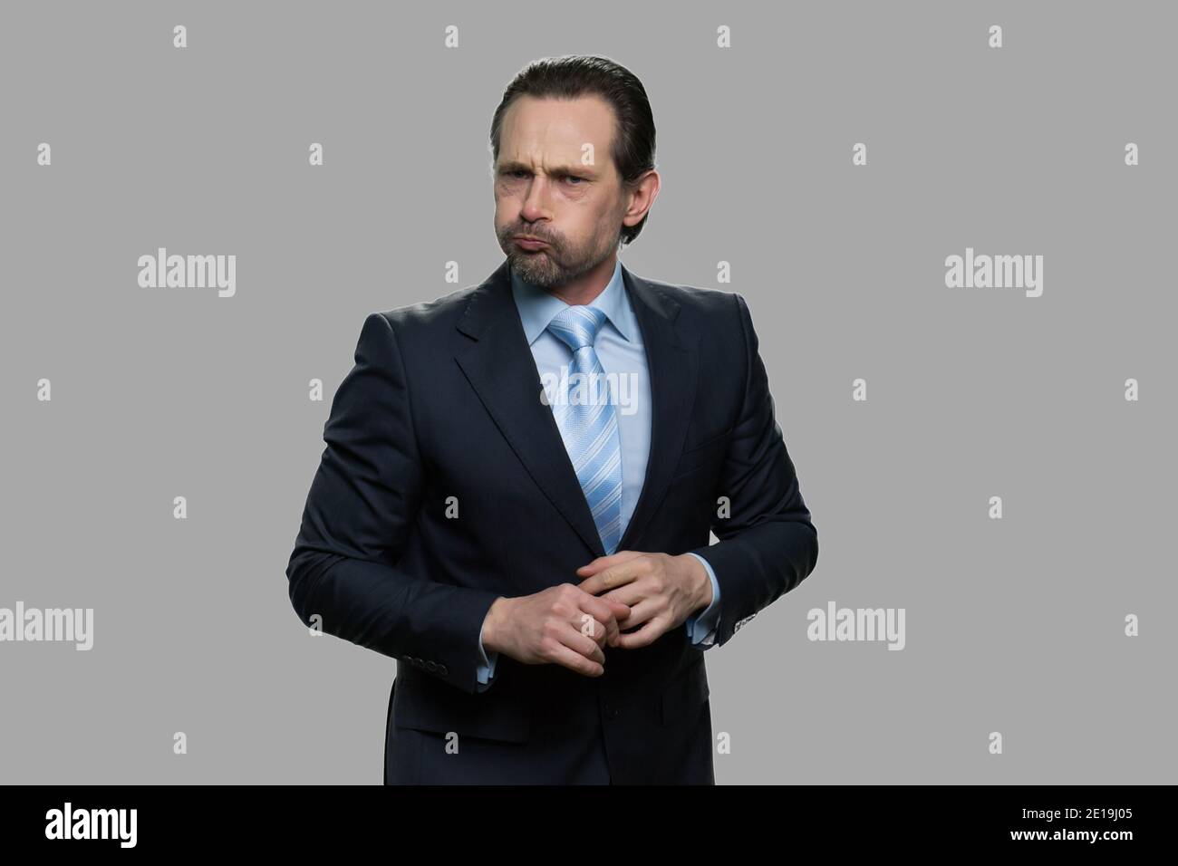 Businessman puffing out cheeks. Stock Photo