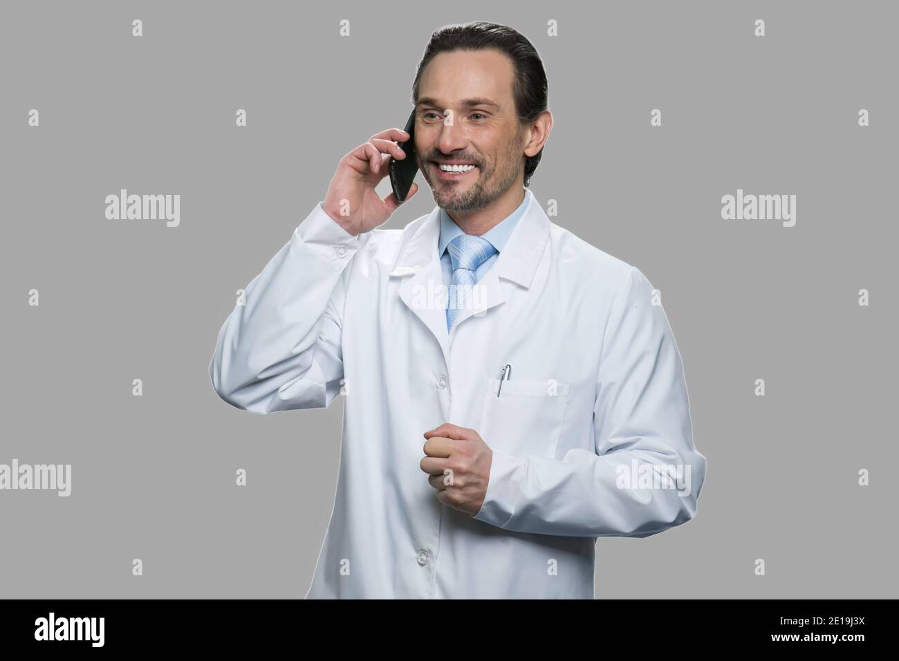 Happy doctor or scientist talking on cell phone. Stock Photo