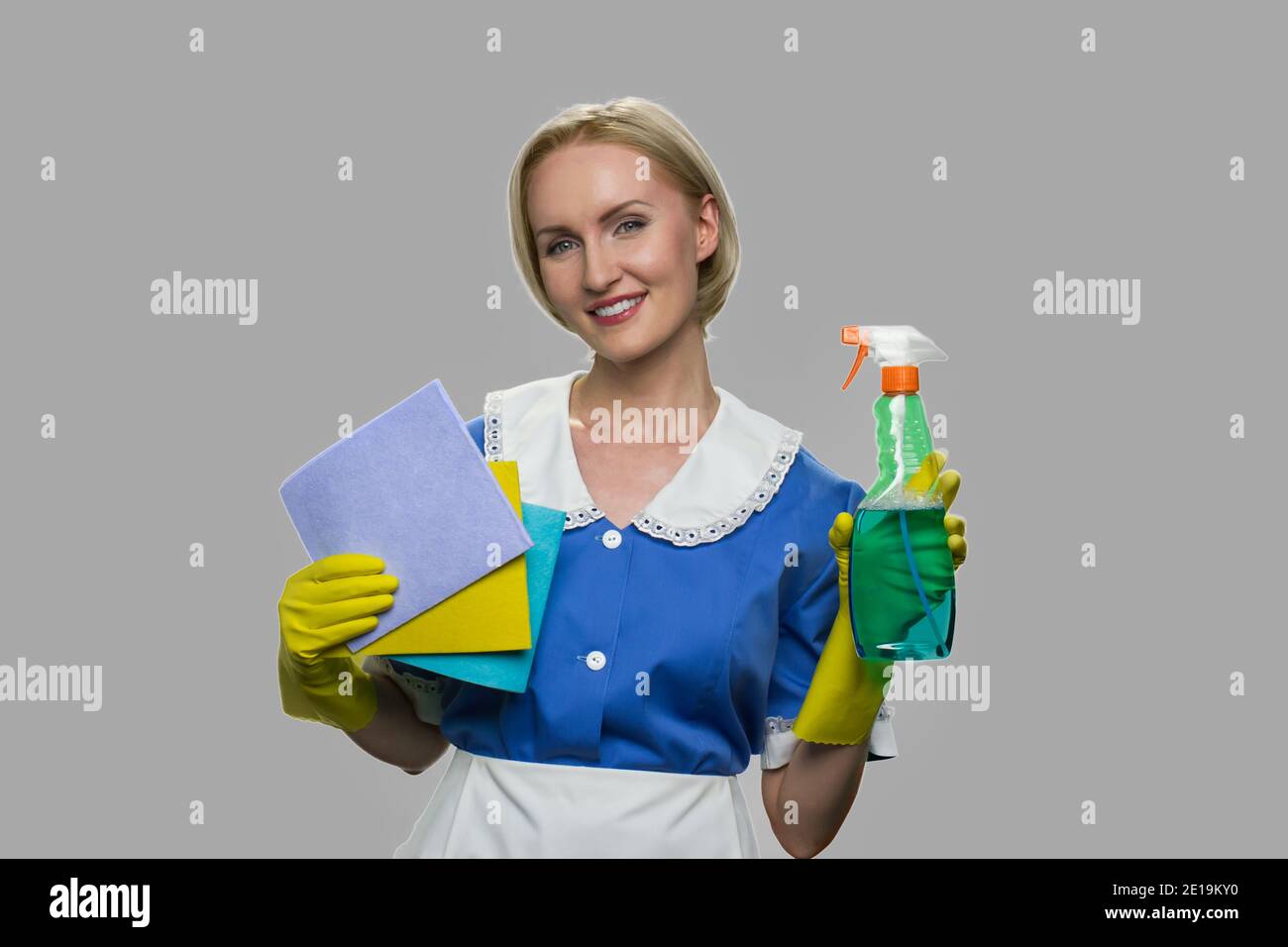 Housekeeper in uniform holding cleaning supplies Stock Photo Alamy