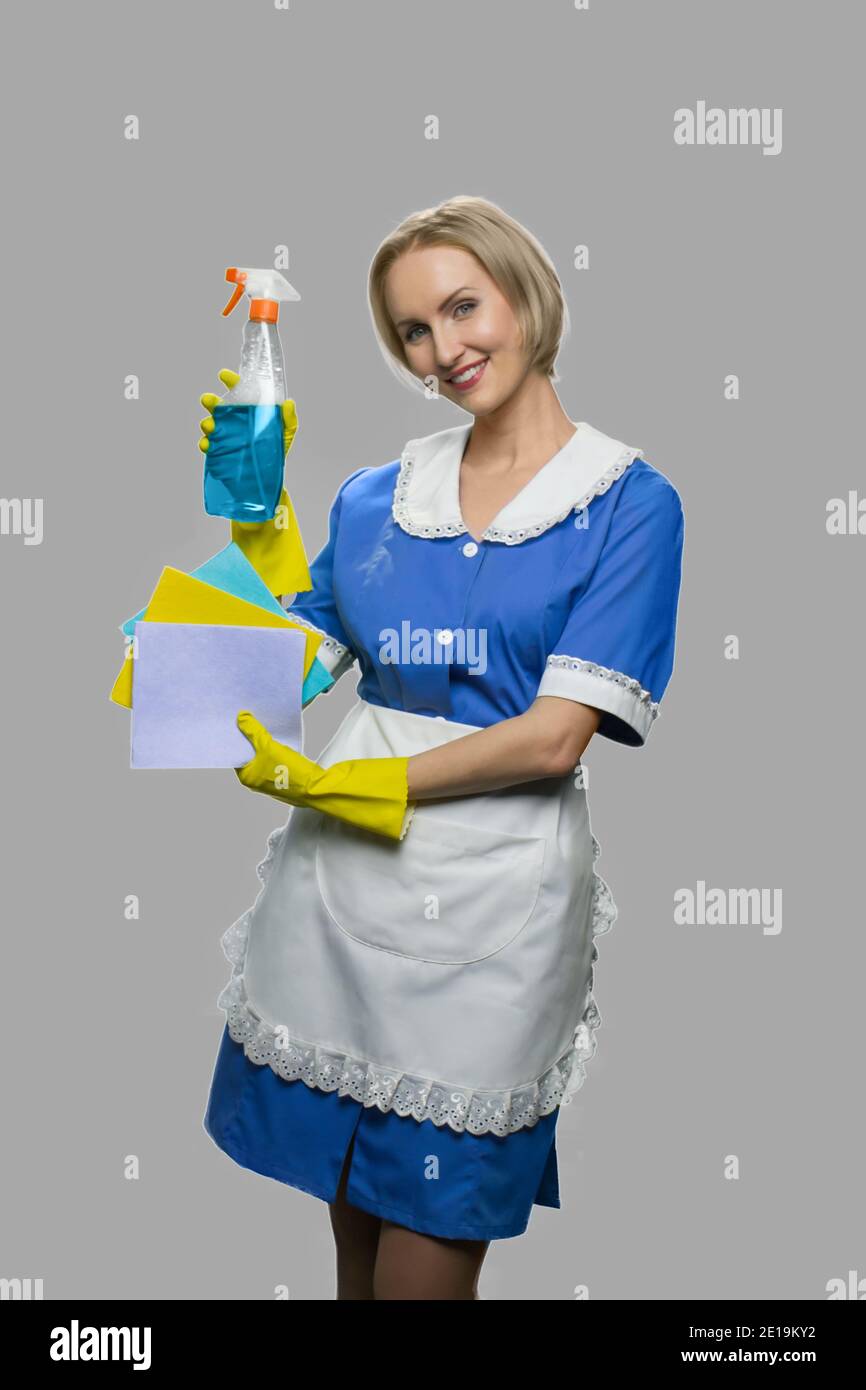 Attractive maid woman holding cleaner spray Stock Photo Alamy