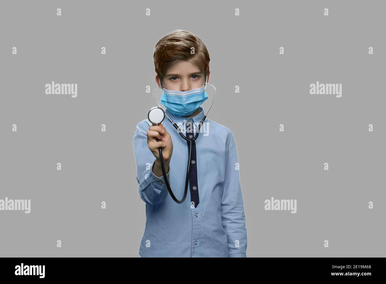 Boy in surgical mask using stethoscope Stock Photo - Alamy