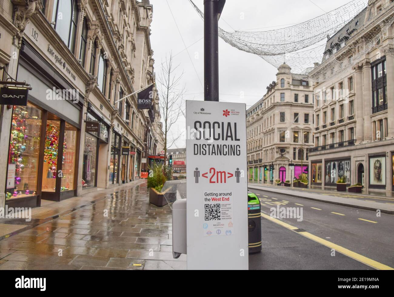 A social distancing sign on a deserted Regent Street in London as England imposes the third national lockdown. Stock Photo