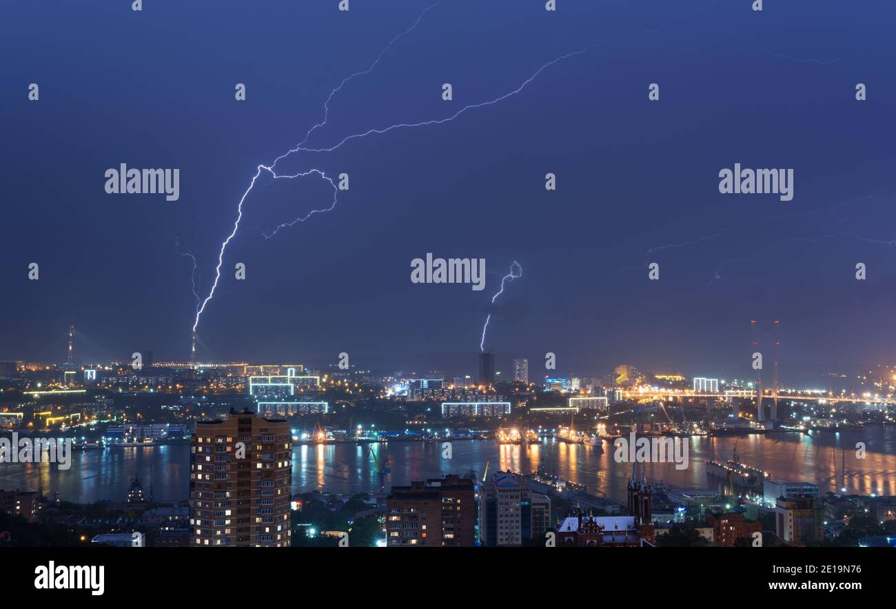 Lightning storm over night city Stock Photo - Alamy