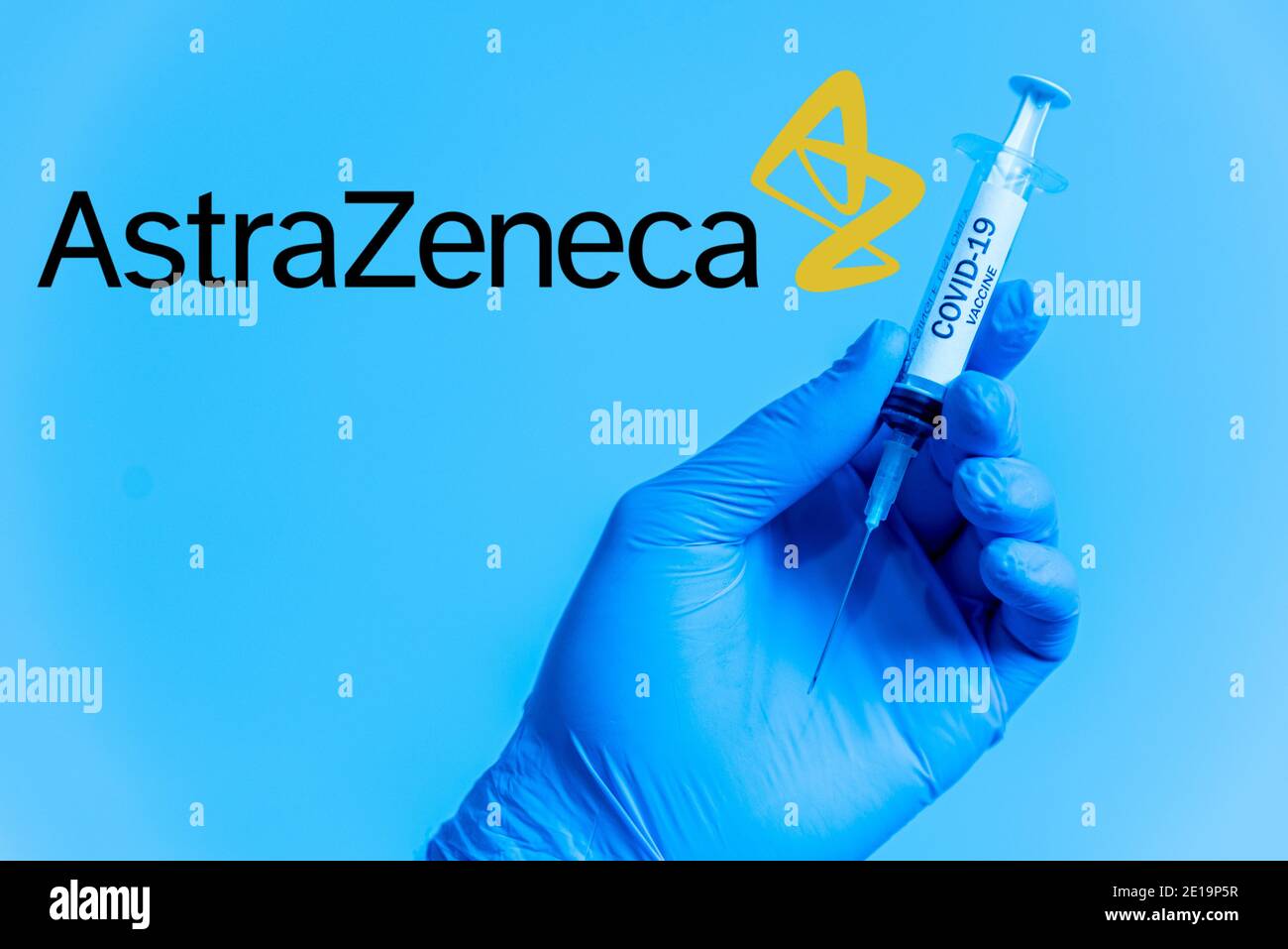 London, UK - 5 january 2021: young male doctor holding astrazeneca covid-19 vaccine vial. concept of science and coronavirus vaccine. face mask and st Stock Photo