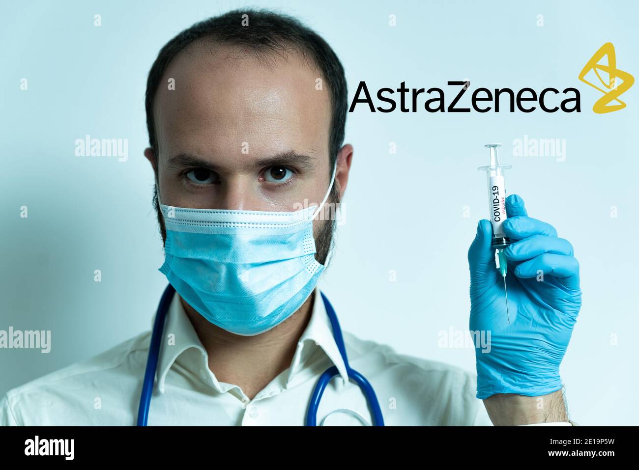 London, UK - 5 january 2021: young male doctor holding astrazeneca covid-19 vaccine syringe. concept of science and coronavirus vaccine. face mask and Stock Photo