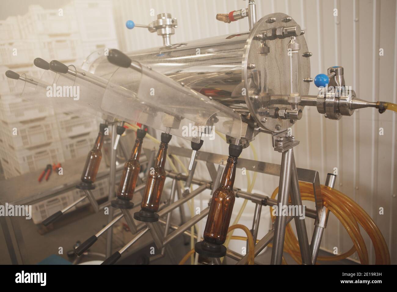 Bottles in bottling apparatus at beer factory Stock Photo Alamy