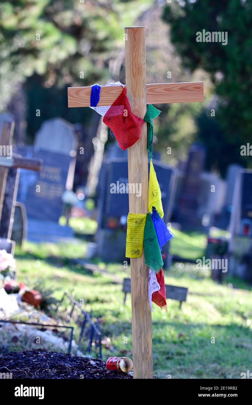 Vienna, Austria. The central cemetery in Vienna. A wooden cross with Buddhist prayer flags at the central cemetery. Stock Photo