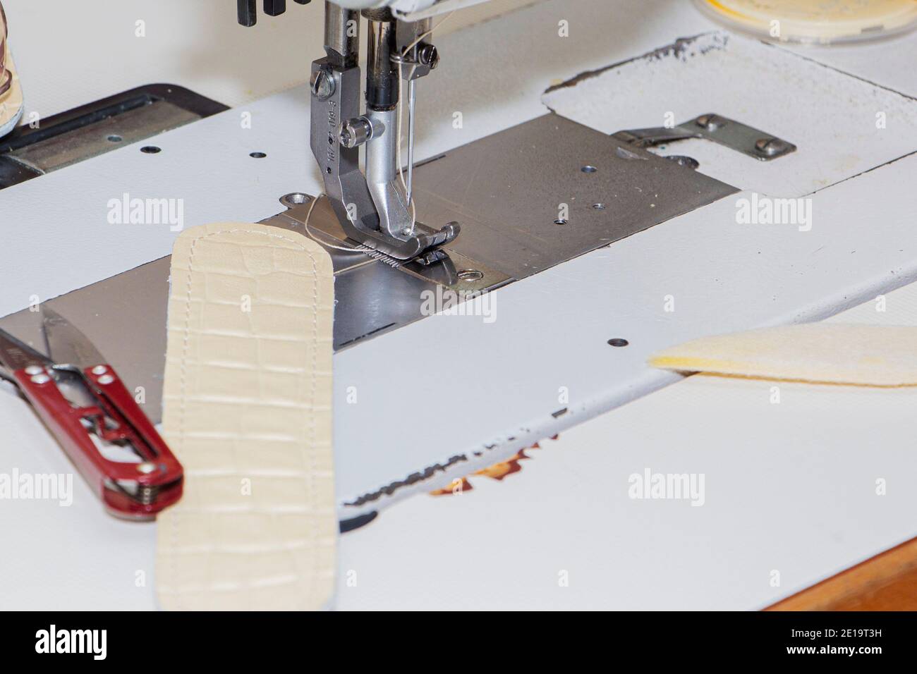 Industrial sewing machine. Clothing manufacturing, tailoring Close up