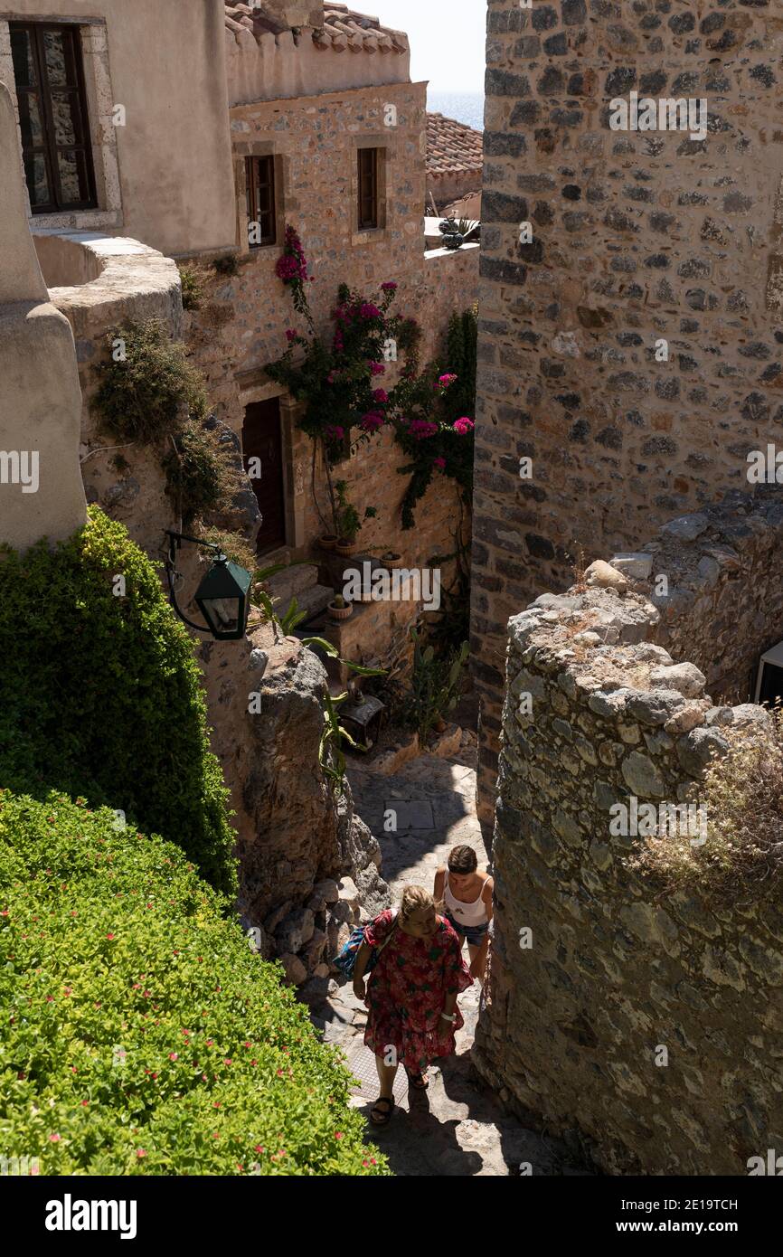 Tourists walk in the castle city of Monemvasia island, Peloponnese region, Greece on July 28, 2020. Stock Photo