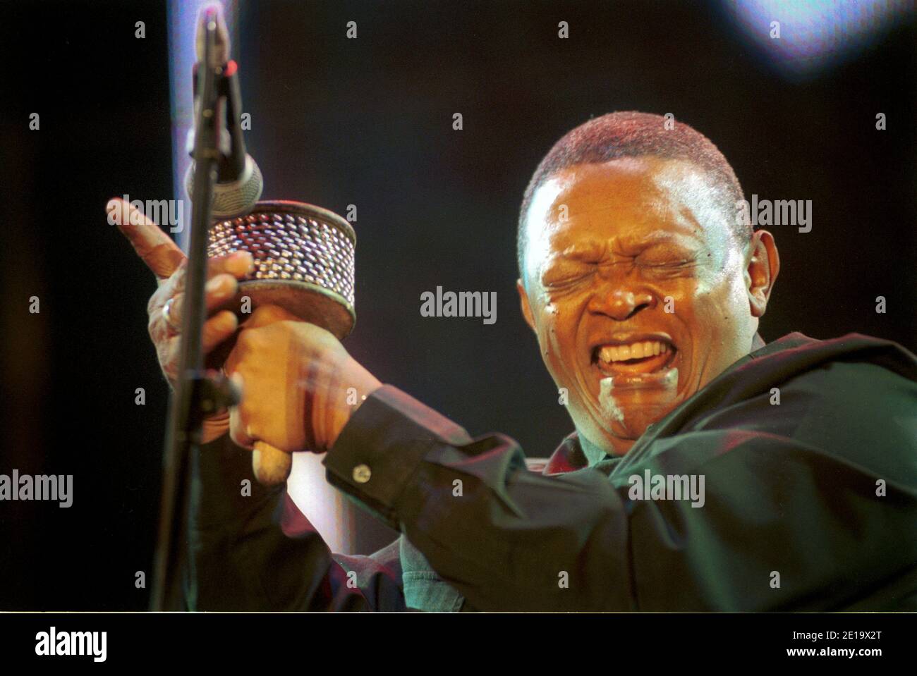 Hugh Masekela, famous South African jazz musician, performs with shaker