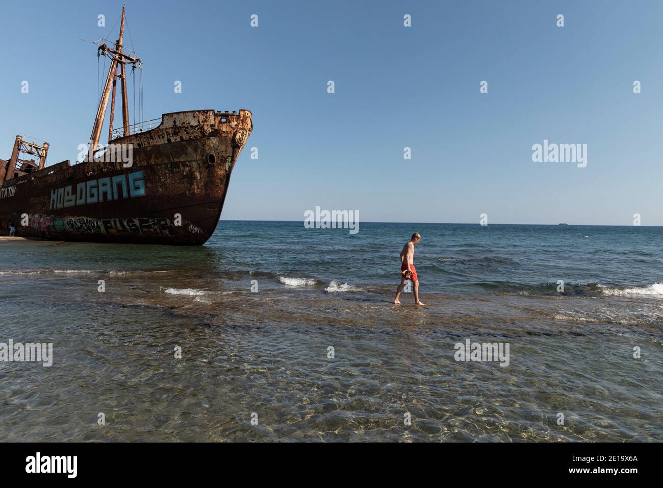 A man walks next to the shipwreck «Dimitrios» in Gytheio, Peloponnese region, Greece on July 29, 2020. / Ναυάγιο «Δημήτριος» στην παραλία Βαλτάκι, Γύθ Stock Photo