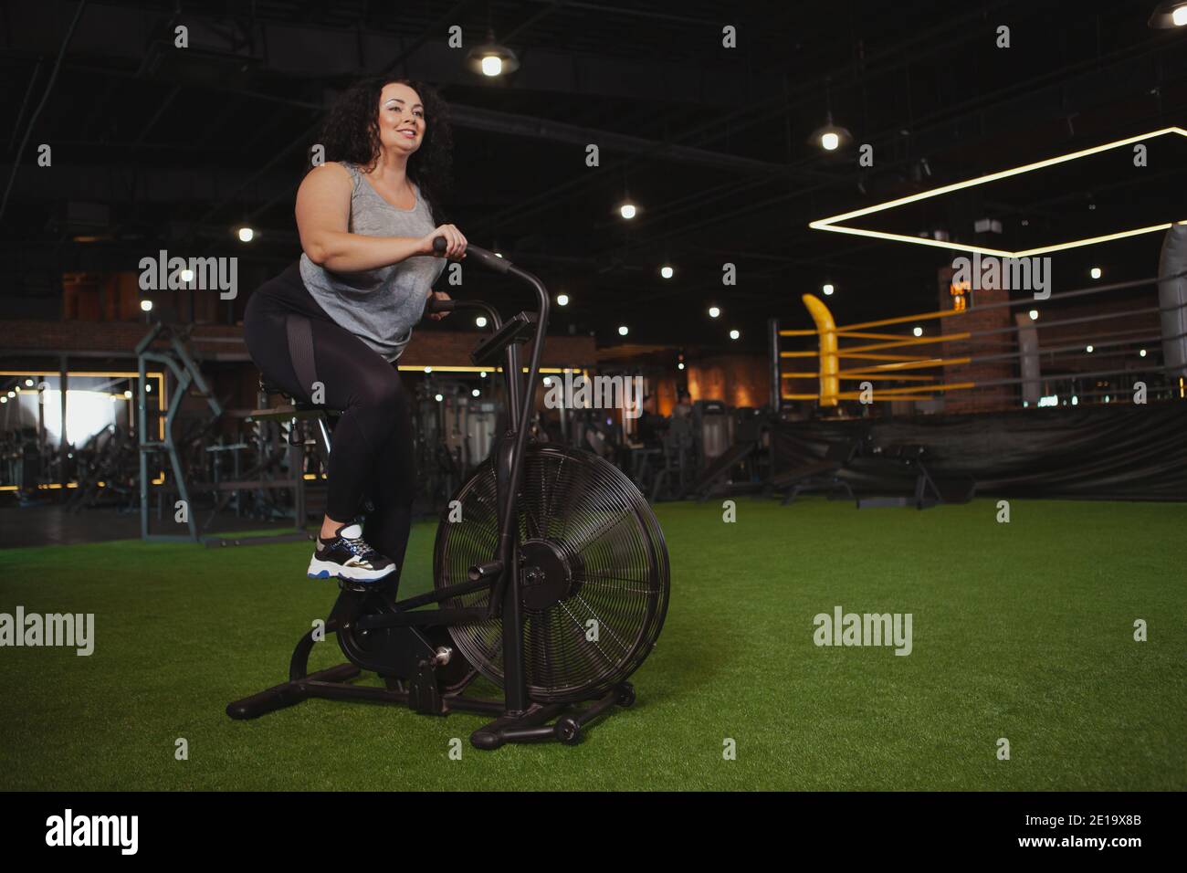 Overweight woman on exercise bike hi res stock photography and images Alamy
