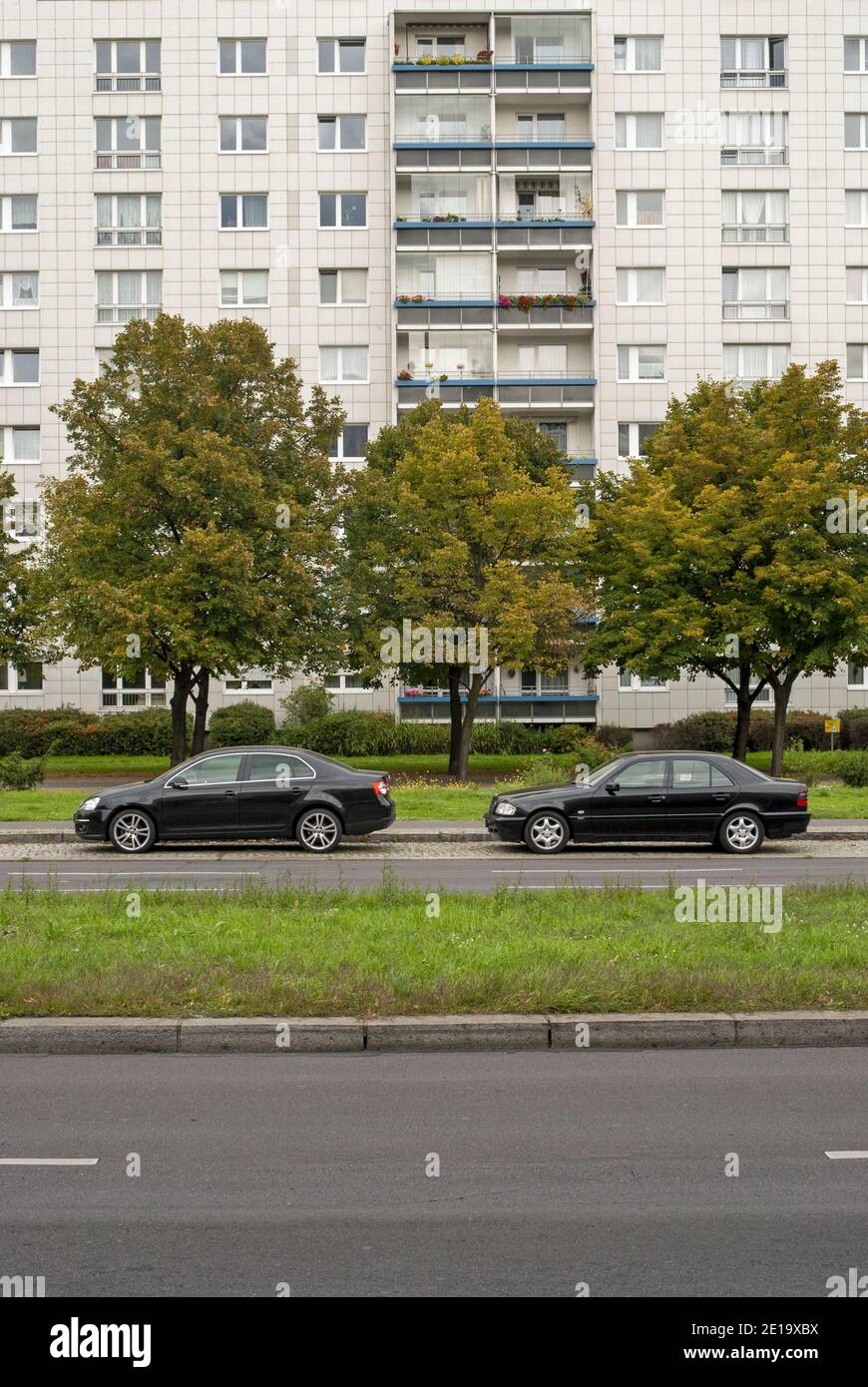 residential building and two black cars parked in  Karl Marx Allee, Berlin, Germany Stock Photo