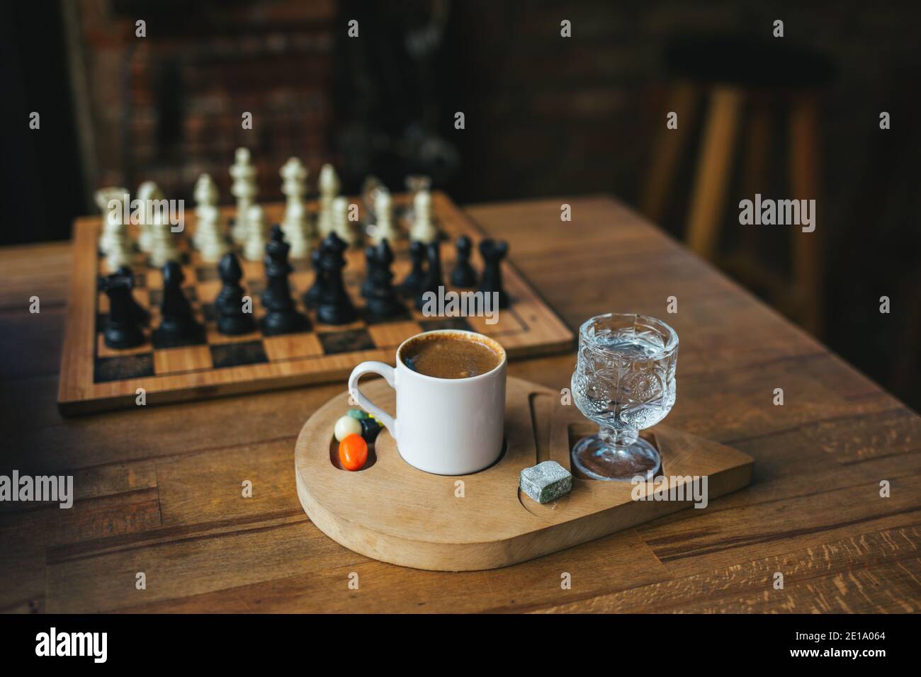 brown chess board with figures on a wooden table in a cafe, playing chess  Stock Photo - Alamy