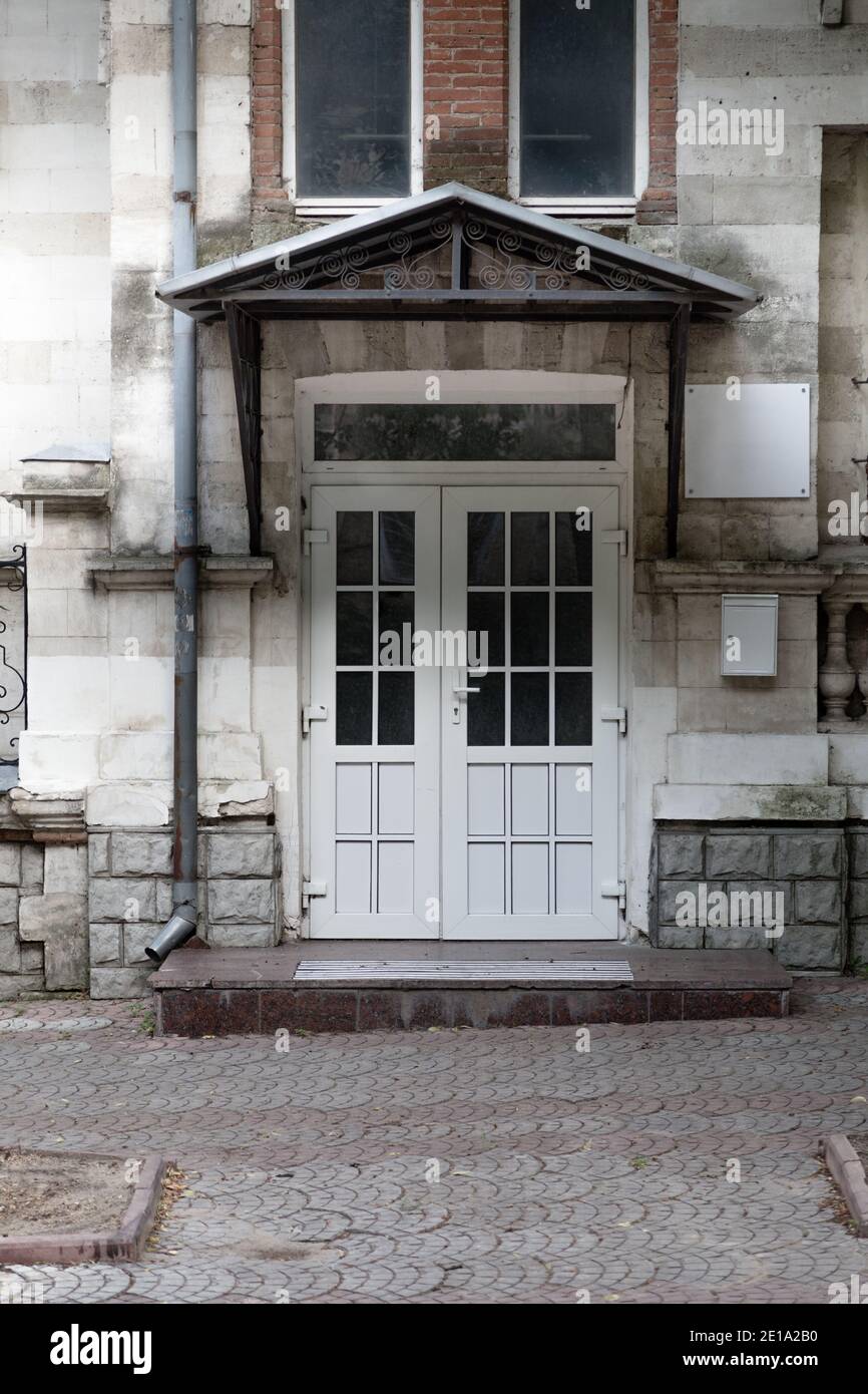 The white door of an old building. It is located on Nicolai Iorga street in Chisinau, Republic of Moldova. Stock Photo
