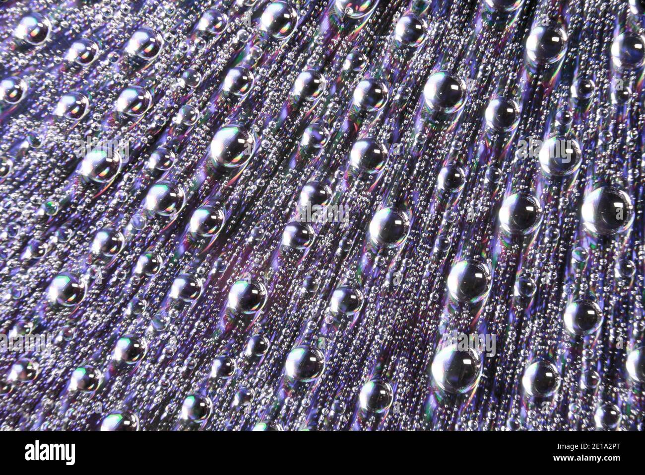 Water droplets on a reflective surface. England UK GB Stock Photo